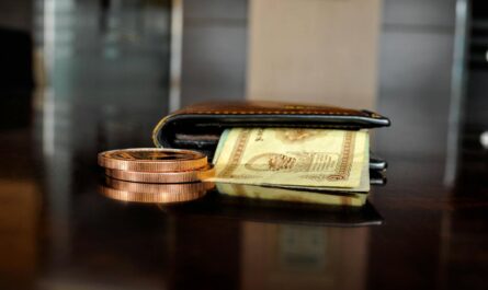 brown leather bifold wallet with banknotes sticking out