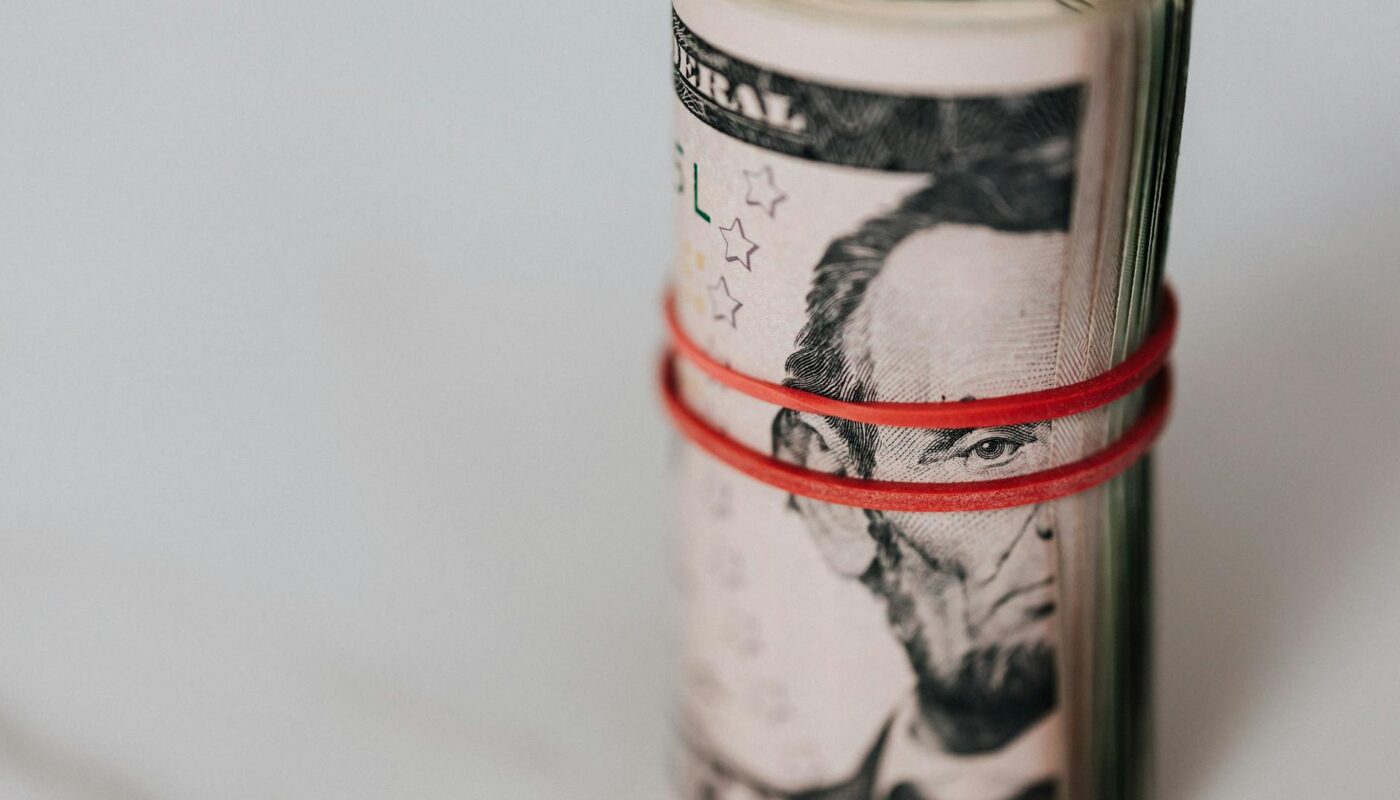 roll of american dollars tightened with red band