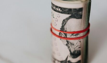 roll of american dollars tightened with red band